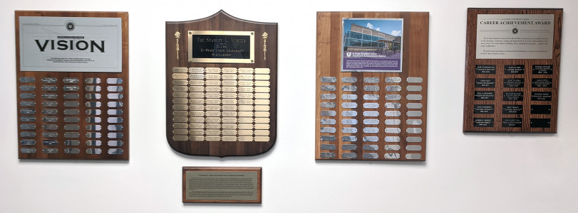 four plaques hanging on wall