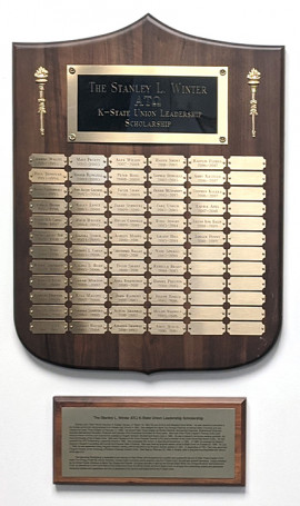 name plaque with descriptive plaque hanging beneath